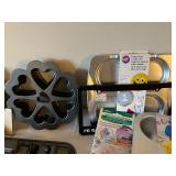 Collection of Specialty Baking Pans and Molds with Cookie Cutters and Cake Accessories