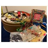 Assorted Craft Supplies and Decorative Items in Tin