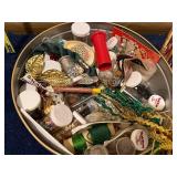 Assorted Craft Supplies and Decorative Items in Tin