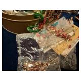 Assorted Craft Supplies and Decorative Items in Tin