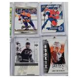 Lot of 8 Hockey Cards All in Magnetic One Touch Cases Featuring Key Players Including Leon Draisaitl, Cale Makar, and Matty Beniers