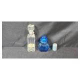 Collection of Vintage Glass Bottles, Brass Candlestick Holders, and Decorative Containers