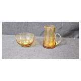 Collection of Vintage Glass Bottles, Brass Candlestick Holders, and Decorative Containers