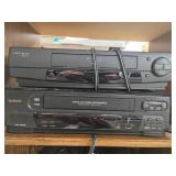 Lot of 3 VCR Players with Cords, Headphones, and Wooden Stand
