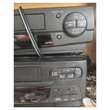 Lot of 3 VCR Players with Cords, Headphones, and Wooden Stand