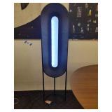 A modern "Race Track" Floor Lamp by Maria Yee.