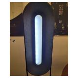 A modern "Race Track" Floor Lamp by Maria Yee.