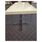 A pair of white side tables with chrome legs by A.L.F. Italy.