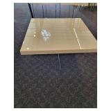 A  white cocktail/coffee table with chrome legs by A.L.F. Italy.