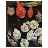 A lot of 27 Snuff Bottles. 8 bottles are missing their stops. Cinnabar. Painted. Etc.