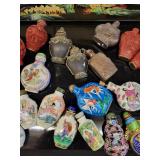 A lot of 27 Snuff Bottles. 8 bottles are missing their stops. Cinnabar. Painted. Etc.