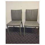 A Pair of Leather Chairs by Cattelan.