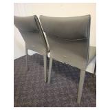 A Pair of Leather Chairs by Cattelan.