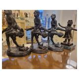 A group of 4 Bronze Statues.  Children Leapfrogging and Blindfolded Girl.