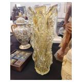 A table full of decor items, animal figures, pottery, glassware, bookends, candle holders, dolls etc.