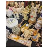 A table full of Porcelain Shoes, Figurines, Music and plain Boxes, Collectibles etc.