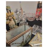 A table full of Figurines, Dolls, Glassware, Leaded Glass Sconce Cover, China, Perfumes etc.