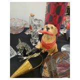 A table full of Figurines, Dolls, Glassware, Leaded Glass Sconce Cover, China, Perfumes etc.