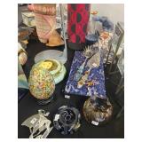 A table full of Figurines, Dolls, Glassware, Leaded Glass Sconce Cover, China, Perfumes etc.