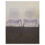 A pair of Calligaris Ice Chairs.