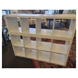 A 2 piece, 12 cubby wood storage unit in white.