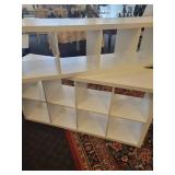 A 2 piece, 12 cubby wood storage unit in white.
