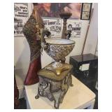 A group lot of items. Rams Head Urn, A Floor Candlestick, Decorative Metal Stand & Abstract Wood Figure.