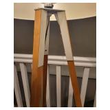 A Tripod Floor Lamp with wood legs.