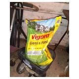 Group of Lawn Care Tools with Spreaders, Trimmers, Tarps, and Supplies