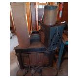 Used Cast Iron Wood Burning Stove with Ornate Feet and Vent Pipes