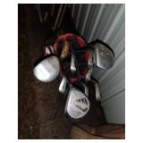 Sports Equipment Lot: Hockey Sticks, Golf Bags with Clubs, and Water Bottle Carrier