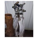 Sports Equipment Lot: Hockey Sticks, Golf Bags with Clubs, and Water Bottle Carrier