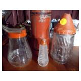 The image features a collection of vintage kitchenware, including several glass salt and pepper shakers and a vintage thermos bottle.