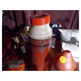 The image features a collection of vintage kitchenware, including several glass salt and pepper shakers and a vintage thermos bottle.