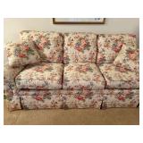 Floral Upholstered Sofa with Rolled Arms and Skirted Base