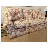 Floral Upholstered Sofa with Rolled Arms and Skirted Base