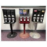 3 Pc Lot; 3 Cast Metal Candy Machines, the 2 Black Machines Have Metal Stands & The Red Has Plastic - No Keys