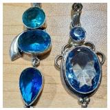 Pair of Blue Gemstone Silver Pendants with Unique Designs