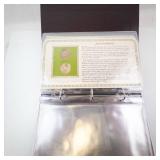 Decorative Collectors Folder with 6 Uncirculated Sacagawea dollar coins and vintage stamps