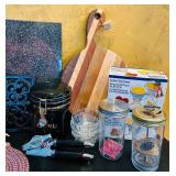 LR - Mixed Kitchenware Lot with Cutting Boards, Trivets, Pitcher, and Accessories