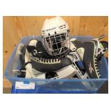 Tote with two pairs of hockey skates, 2 pairs of figure skates, and hockey helmet