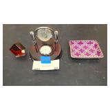 Living room décor = Red cube, clock with globe, and decorative small dish