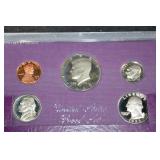 Two 1985s United States Mint 5-Coin Sets - Purple Presentation Wallets