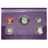 Two 1985s United States Mint 5-Coin Sets - Purple Presentation Wallets