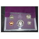 Two 1985s United States Mint 5-Coin Sets - Purple Presentation Wallets
