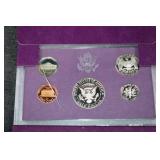 Two 1985s United States Mint 5-Coin Sets - Purple Presentation Wallets