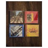 4 Beatles CDs.