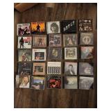 Collection of 25 rock music CDs, which are considered collectibles.