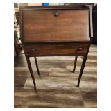 Antique slant-top desk, also known as a secretary desk or bureau.