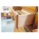 Wooden 5-drawer dresser with ornate brass-toned hardware